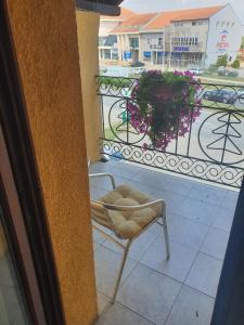 a chair sitting on top of a balcony with a view at Guest house Vila Bor in Novi Sad +6 photos