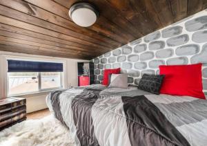 een slaapkamer met een groot bed en een stenen muur bij Ashore the Clouds Glamping awaits in Woodland Park