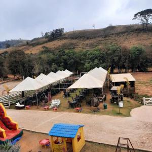 an aerial view of a play park with white tents at Hotel Fazenda Recanto in Ouro Branco