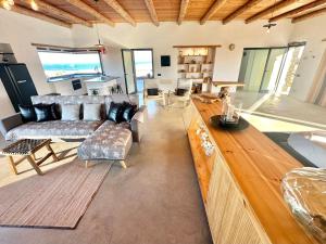 a large living room with couches and a table at Casita Tahona con vistas de infarto al mar y volcanes con absoluta privacidad in Parque Holandes +24 photos