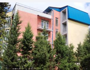 a building with trees in front of it at Diamond Hotel in Ureki