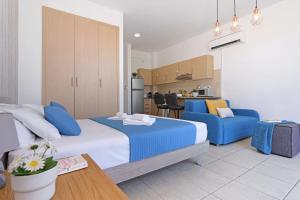 a bedroom with a large bed and a kitchen at MERYL - Coralli Beachfront Apartment in Protaras +28 photos