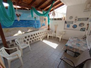 a large aquarium in a room with chairs and a table at Peristerianos apartments in Nea Skioni