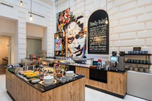 a restaurant with a counter with food on it at T62 Hotel in Budapest