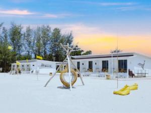 a sculpture in front of a building with yellow shoes at De Mer Resort Rayong in Ban Ao Makham Pom
