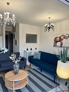 a living room with blue couches and a table at La Terra Luxury apartment in Kivérion