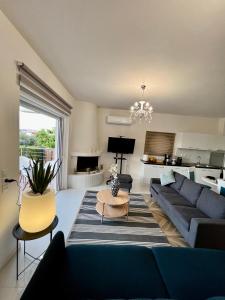 a living room with a couch and a table at La Terra Luxury apartment in Kivérion