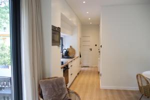 a kitchen with white walls and a table and chairs at Boshuis Dreamstay Gorssel in Gorssel