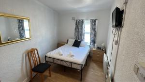 a small bedroom with a bed and a television at Henson hotel in Blackpool