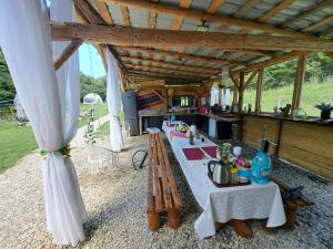 a tent with two tables and a kitchen at Forest Glamping in Braşov