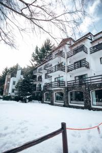 a building with snow in front of it at Apartur Catedral in San Carlos de Bariloche