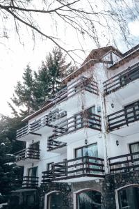 a white building with balconies on the side of it at Apartur Catedral in San Carlos de Bariloche