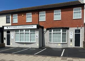 a red brick building with a sign on it at BlackBird Luxury Accommodation Room 6 in Blackpool