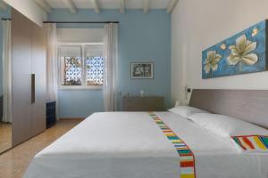 a bedroom with a large bed and a window at Villa Miramare by Perle di Puglia in Torre Suda +45 photos