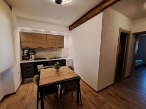 a kitchen and dining room with a wooden table and chairs at Struttura Monte Olimpo in Porto Torres