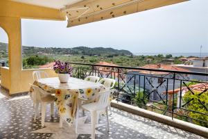 a table and chairs on a balcony with a view at PANORAMA in Potos +3 photos