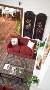 a red couch in a living room with a rug at El Golf Hotel Boutique in Lima +133 photos