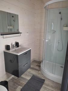 a bathroom with a sink and a shower at Chatka Daisy A,B in Pakoštane +43 photos