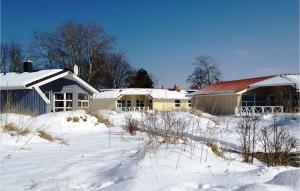 a house is covered in snow in front at Dünenpark 15 - Dorf 6 in Travemünde