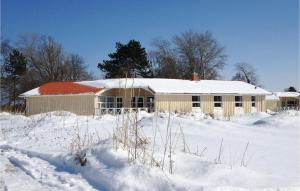 a building covered in snow in a snowy field at Dünenpark 15 - Dorf 6 in Travemünde