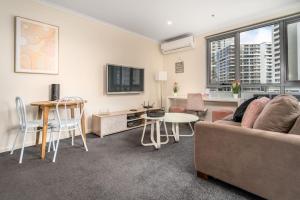 a living room with a couch and a table at 2BR Apt in the heart of the Gungahlin Town Centre - Hosted by CanStay in Harrison