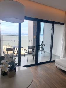 un soggiorno con tavolo e vista sull'oceano di Căn hộ cao cấp tại ALaCarte Ha Long Bay Hotel Residence a Ha Long