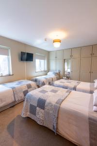 a room with four beds in a room at AVALON HOUSE in Galway