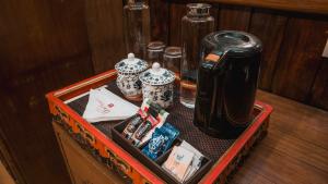 a wooden table with a tray with a tea kettle at Orchid Lords Eco Inn Gangtok in Gangtok