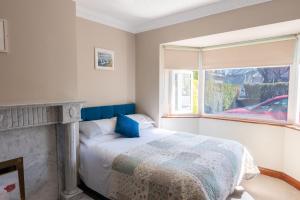 a bedroom with a bed and a window at AVALON HOUSE in Galway