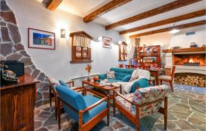 a living room with blue furniture and a fireplace at 2 Bedroom Lovely Home In Ozalj in Tomašnica