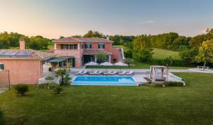 an aerial view of a house with a swimming pool at Villa Village in Tinjan