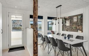 a dining room with a white table and chairs at 3 Bedroom Amazing Home In Storvorde in Storvorde