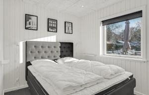 a large bed in a room with a window at 3 Bedroom Amazing Home In Storvorde in Storvorde +15 photos