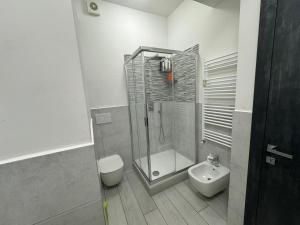 a bathroom with a shower and a toilet and a sink at camera con bagno privato in Rome