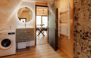 a bathroom with a washer and dryer in a house at LES CHALETS DE COYRON. in Coyron