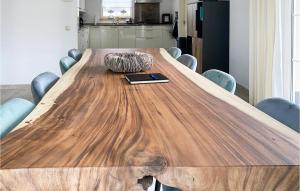 a wooden conference table with a book and a tablet at Horsterhoek in Zeewolde