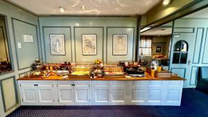 a counter in a room with food on it at Hotel Dreieich in Langen