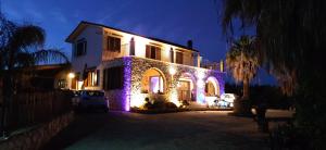 a house with lights on the front of it at night at B&B Della Via Francigena in Agrigento