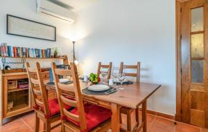 a dining room with a wooden table and chairs at Lovely Home In Chiclana De La Fronter in Chiclana de la Frontera