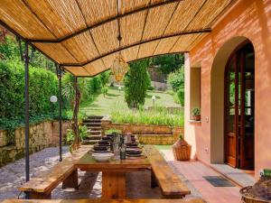 a patio with a wooden table with plates on it at Stalla - Villa with garden in the historic center in Florence +69 photos