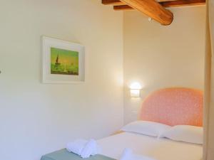 a bedroom with a bed with a picture on the wall at Stalla - Villa with garden in the historic center in Florence