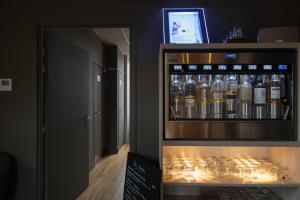 a drink cabinet with bottles of alcohol in a room at Syrah in Ruoms +8 photos