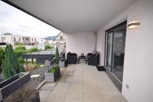 a patio with chairs and tables on a building at Appartement Sélestat in Sélestat