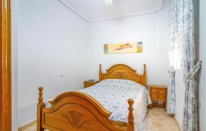 a bedroom with a wooden bed in a room at Amazing Apartment In Torrevieja in Torrevieja