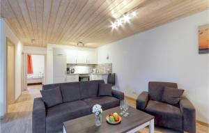 a living room with two couches and a table at Ferienhaus 12 Altefähr in Altefähr