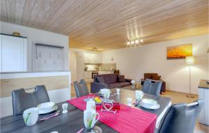 a dining room and living room with a table and chairs at Ferienhaus 12 Altefähr in Altefähr