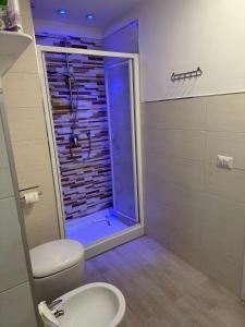 a bathroom with a shower with a toilet and a sink at On The Beach SORRENTO in Massa Lubrense