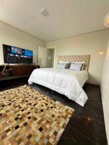 a bedroom with a large bed and a flat screen tv at Beach House Delegado Marcio in Balneário Camboriú +83 photos