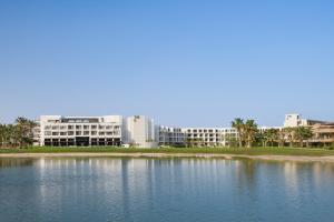 a large body of water with buildings in the background at The G Einbay Golf Resort in Ain Sokhna