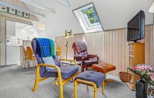 a living room with chairs and a tv at 2 Bedroom Gorgeous Home In Glesborg in Glesborg